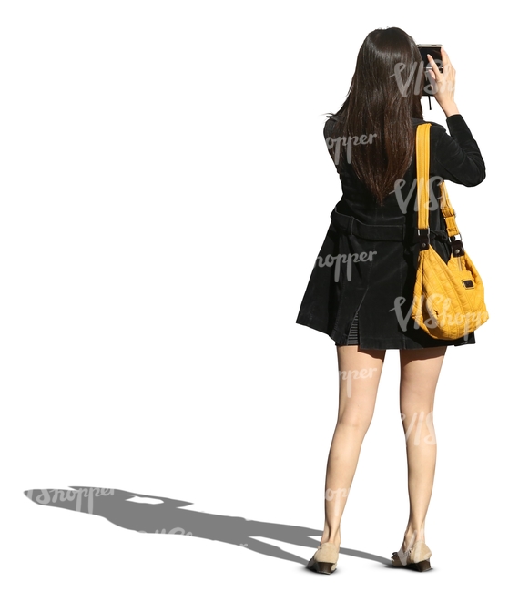woman with long dark hair taking a picture with her smartphone