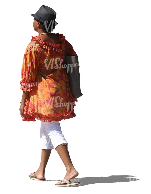 black woman with a hat and in a colorful blouse walking