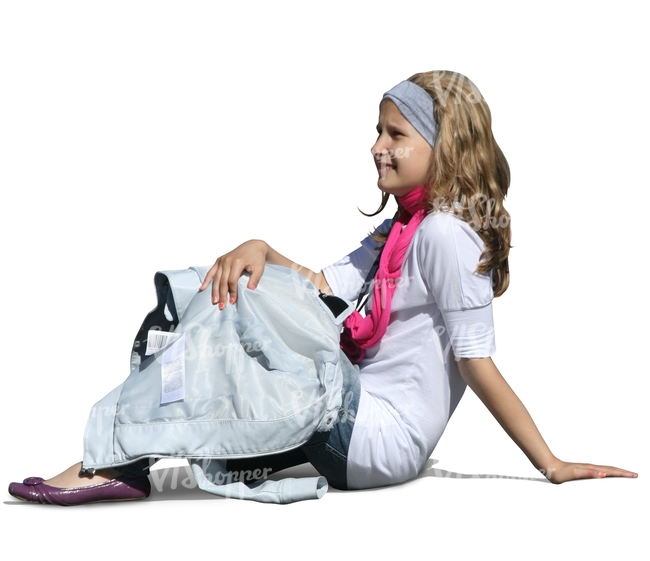 young girl sitting on the gound