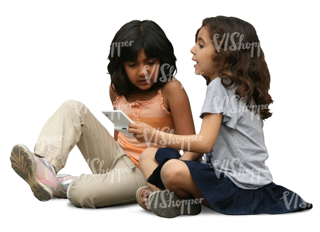 two dark haired girls sitting on the ground and playing