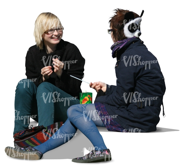 two girls sitting and talking on the sidewalk