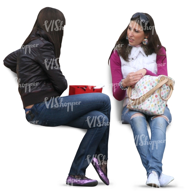 two girls with long dark hair sitting and talking