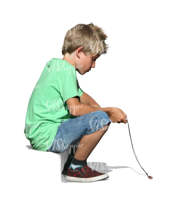 A young boy sitting on the sidewalk