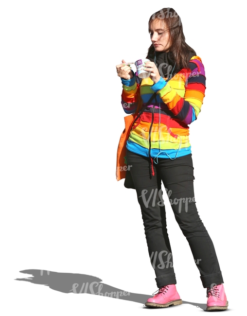 woman in a striped pullover standing and eating icecream