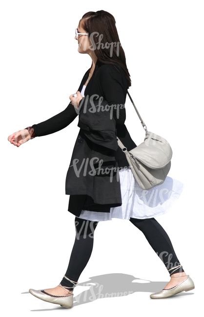 young woman in black and white clothes walking