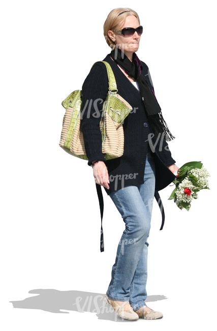 woman holding a bouquet of flowers walking