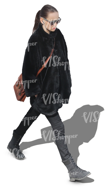 woman in a black fur coat walking hands in her pocket