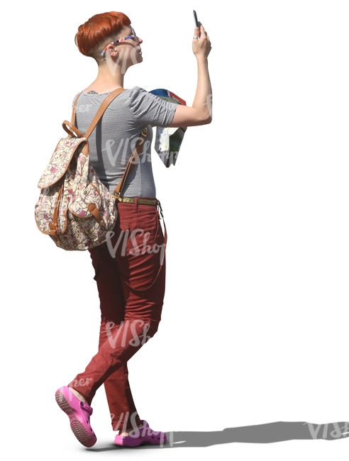 woman walking and taking a picture with a phone