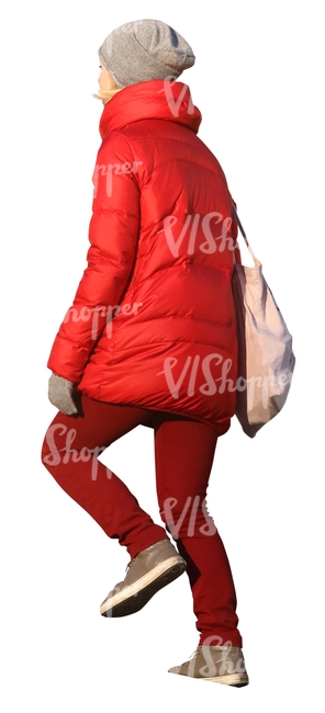 woman in a red winter coat walking up the stairs