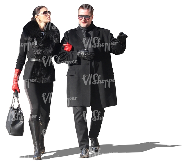 posh couple dressed in black walking arm in arm