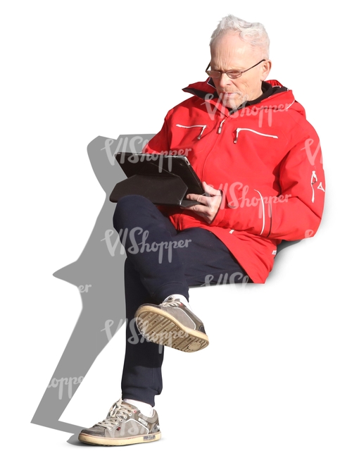 elderly man sitting and reading a tablet