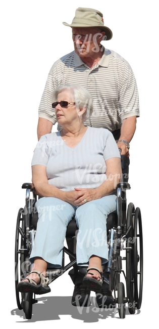 elderly man pushing a woman in a wheelchair