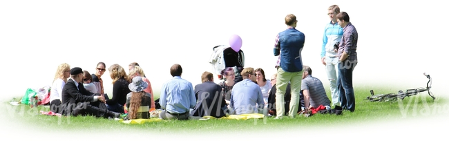 group of people sitting on the grass