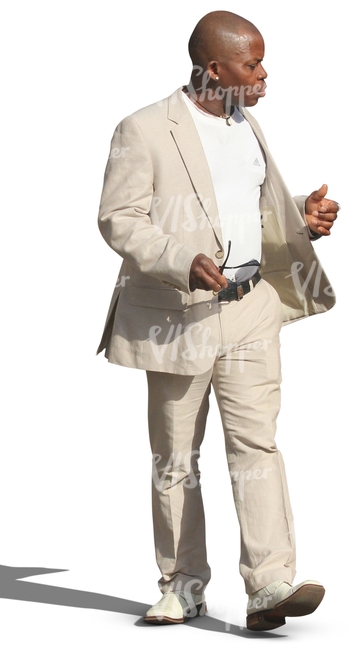 black man in a white suit walking