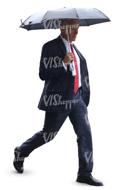 businessman with an umbrella walking in the rain
