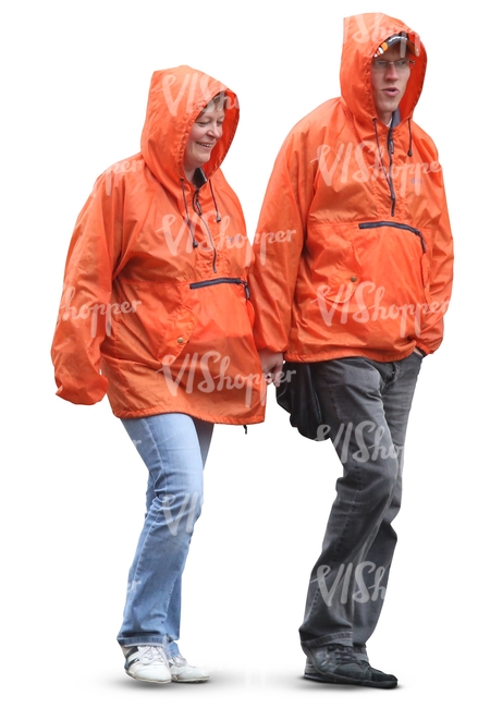 two people in orange raincoats walking hand in hand