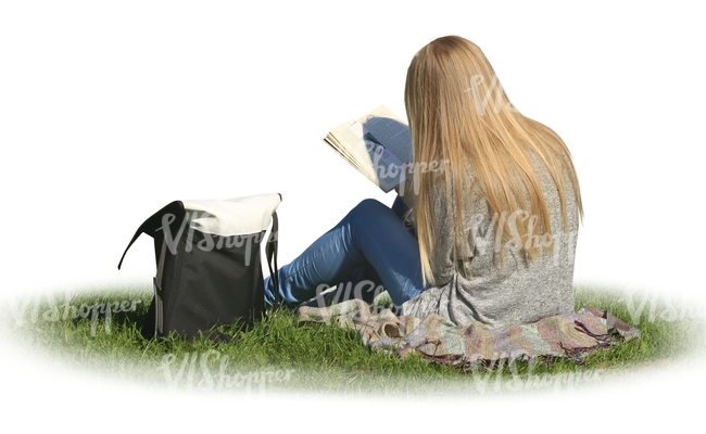 woman sitting on the grass and reading