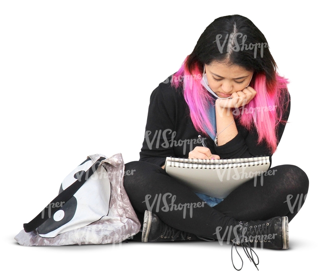 asian woman sitting and writing in her notebook