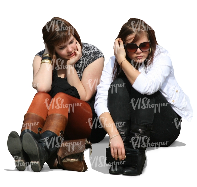 Two girls sitting on the sidewalk