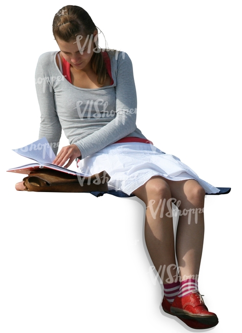 A girl sitting and reading a book