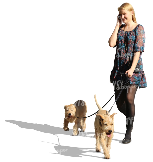 woman with two dogs talking on the phone