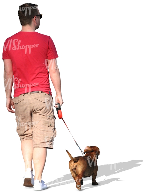 man in a red T-shirt walking a dog