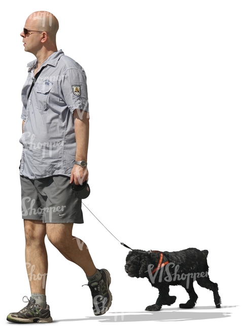 A man walking a black dog