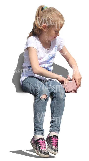 young girl sitting and looking in her handbag