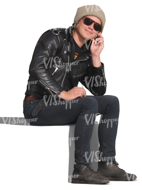 man in a leather jacket sitting and talking on the phone