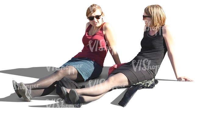 two women sitting with streched out legs