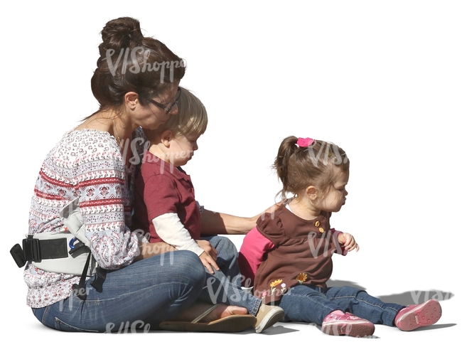 woman with two children sitting on the ground