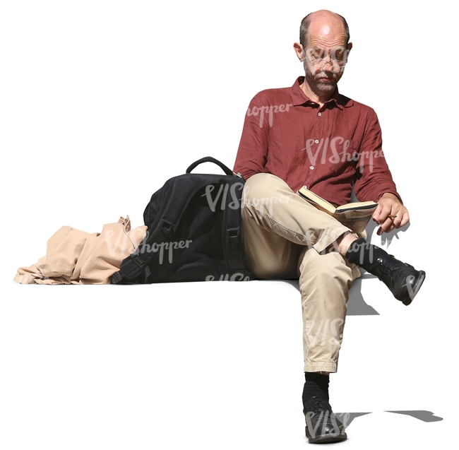 man sitting and reading a book