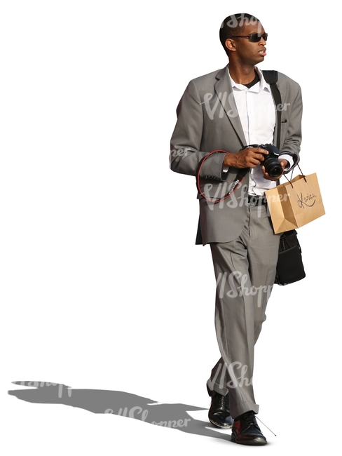 black man in a grey suit walking