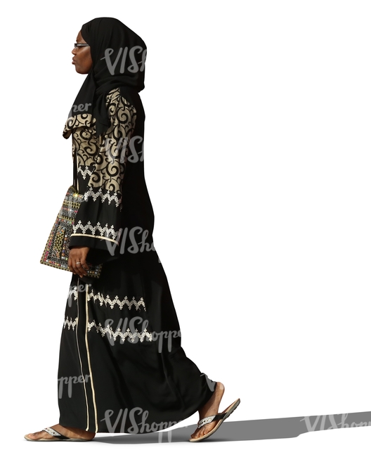 muslim woman in a decorated abaya walking