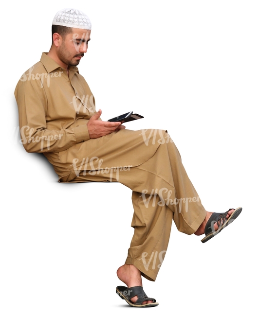 arab man sitting and looking at his phone