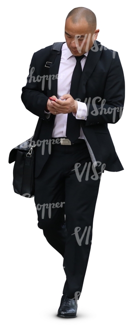 asian businessman walking while looking at his phone