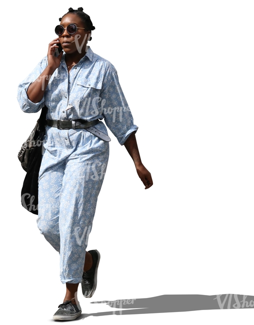 black woman walking and talking on the phone