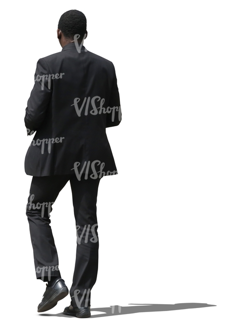 african businessman in a black suit walking