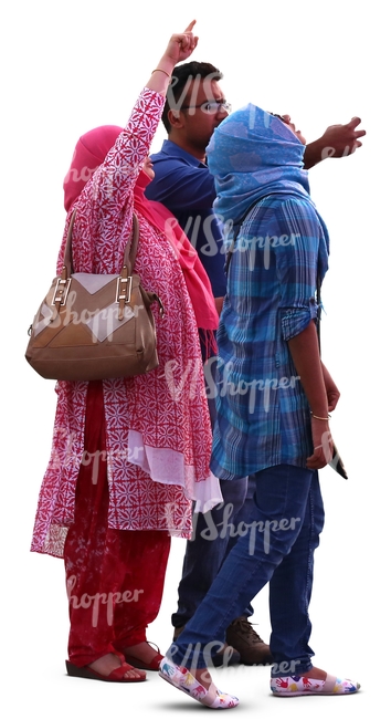 man and two hindu women standing and looking at smth