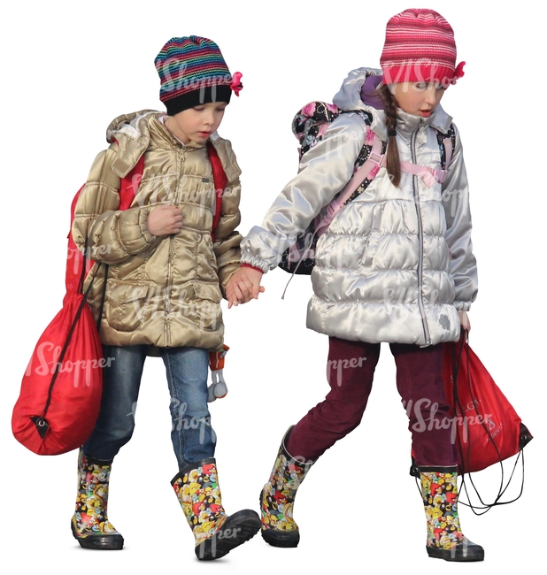 two young girls in autumn coats walking hand in hand