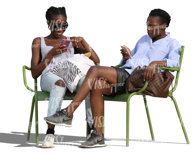 two cut out african women sitting and smiling