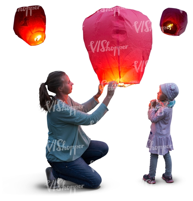 mother and daughter lighting a sky lantern