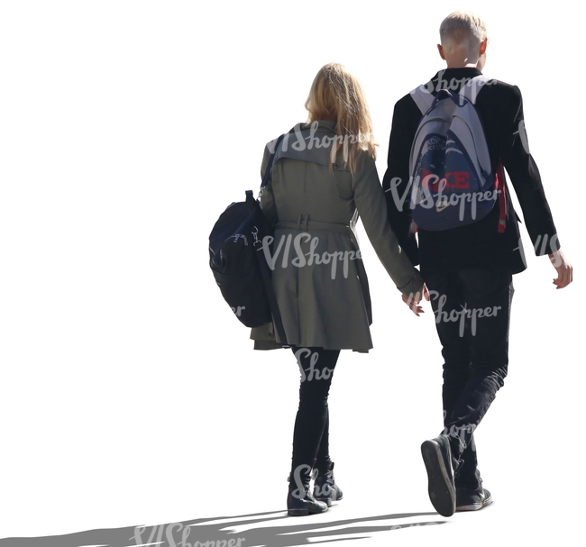 backlit couple walking hand in hand