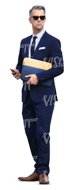 businessman standing with a phone in his hand