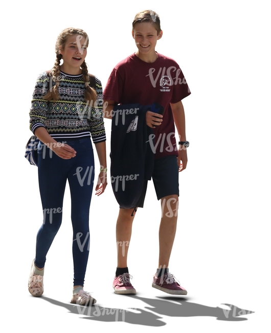 backlit teenage boy and girl walking and talking