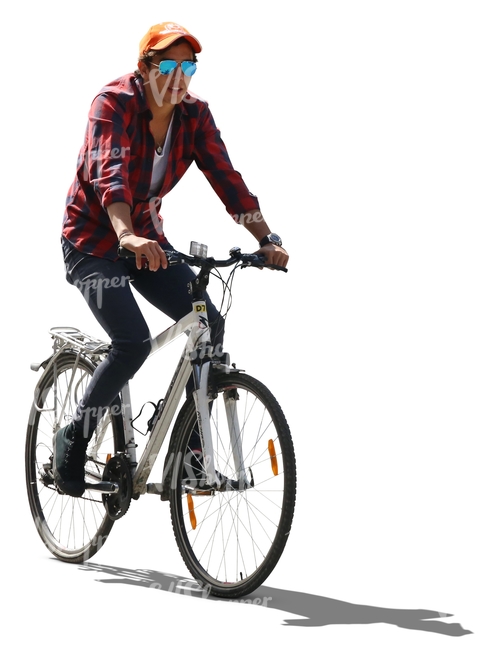 backlit young man riding a bike