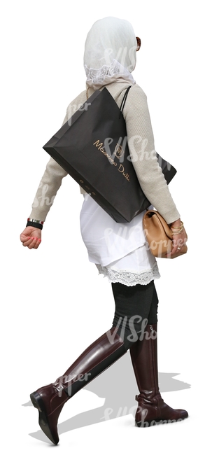 muslim woman walking with a large shopping bag