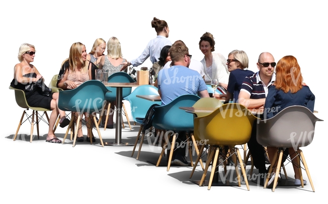 group of people sittnin in a street cafe in summertime