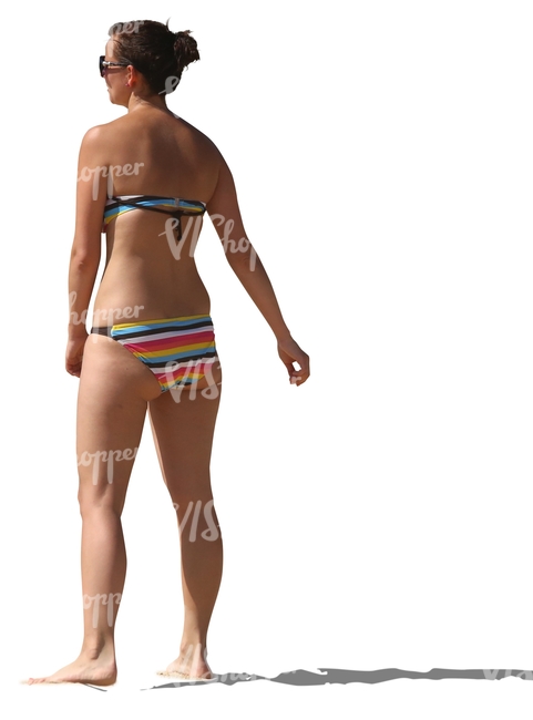 woman in a bikini standing on the beach