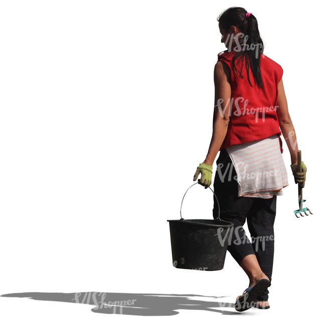 woman with a rake and a bucket walking